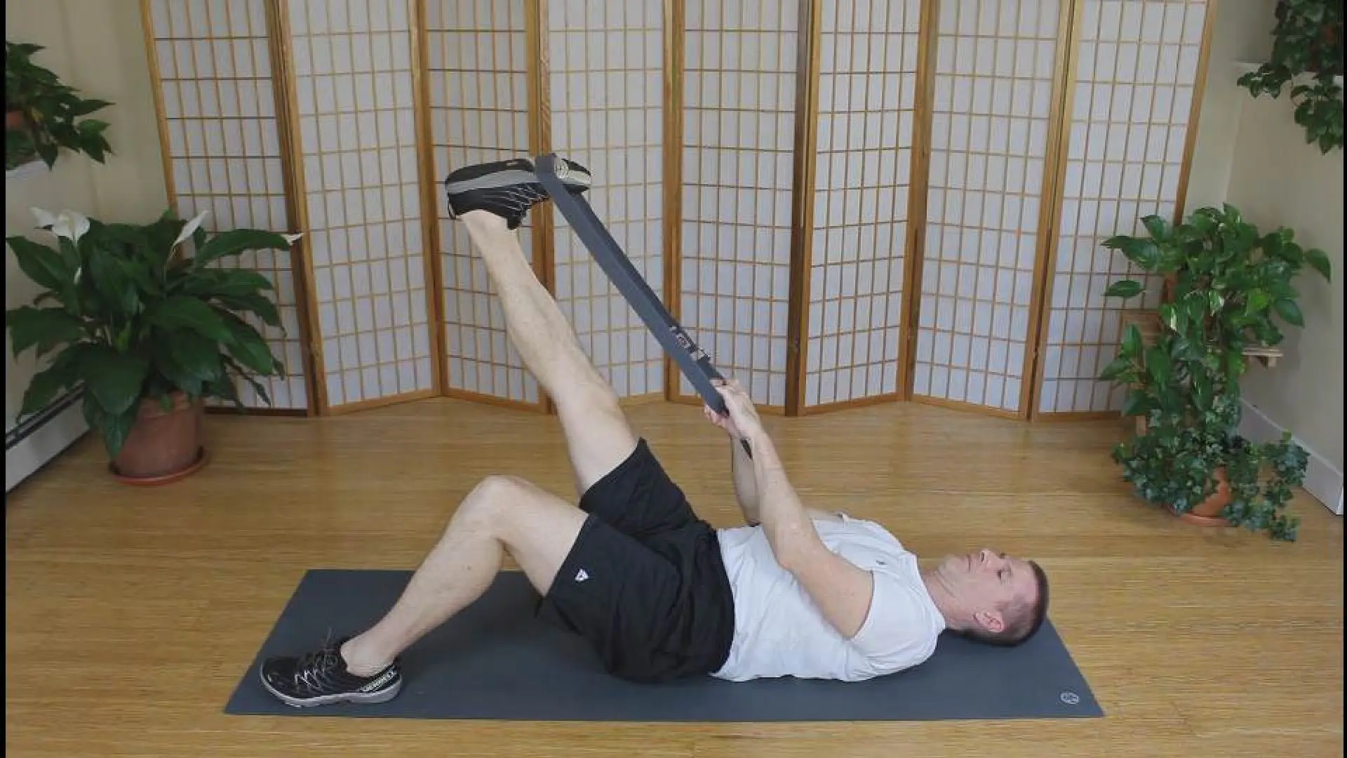 Hamstring Stretch Using Yoga Strap Supine hamstring stretch using yoga strap to assist